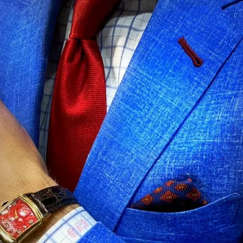 Navy blazer with red tie and luxury watch styled for a professional work environment by Bespoke By CB Miami