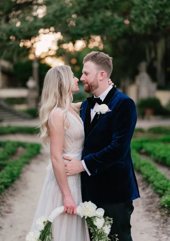 Navy velvet dinner jacket worn by a groom with formal accessories, custom made by Bespoke By CB Miami