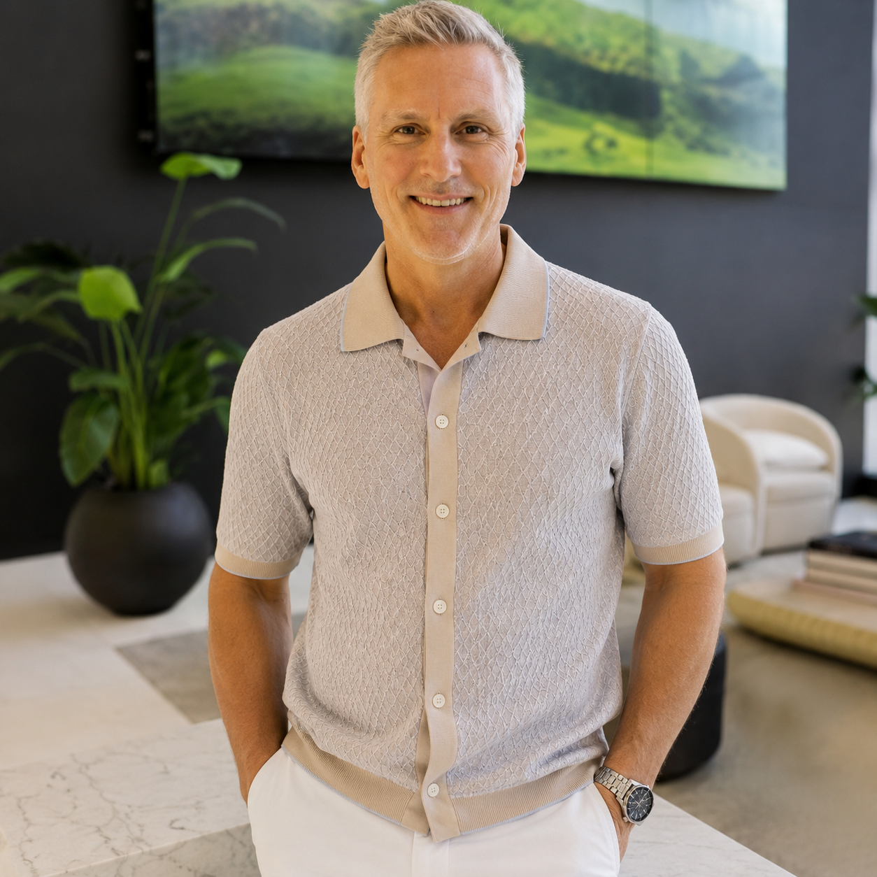 Man wearing a cream button-through knit polo shirt styled for smart casual occasions.