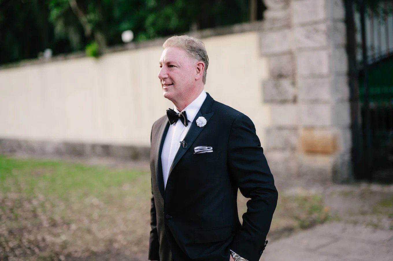Father of the bride in a tailored formal tuxedo demonstrating premium fit and wedding appropriate styling