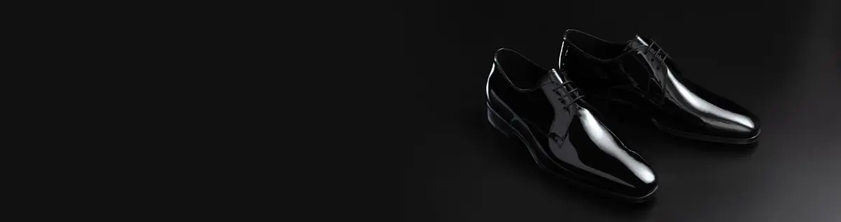 Polished black patent leather oxford dress shoes for formal occasions.
