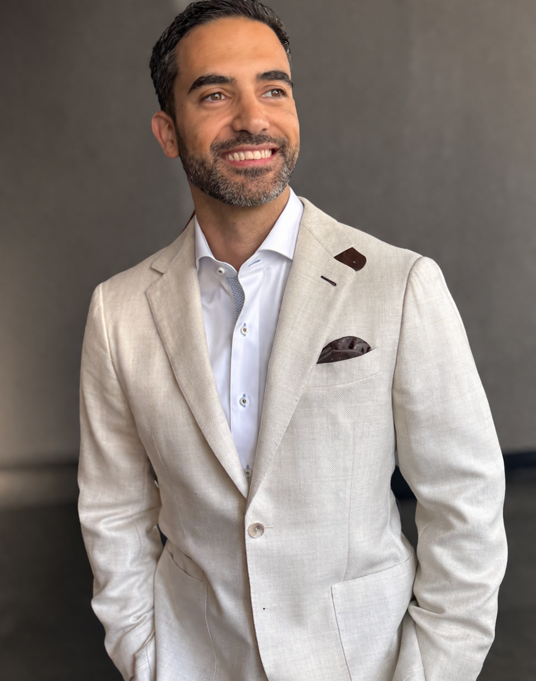 Custom beige suit paired with a light shirt and loafers for a casual elegant look