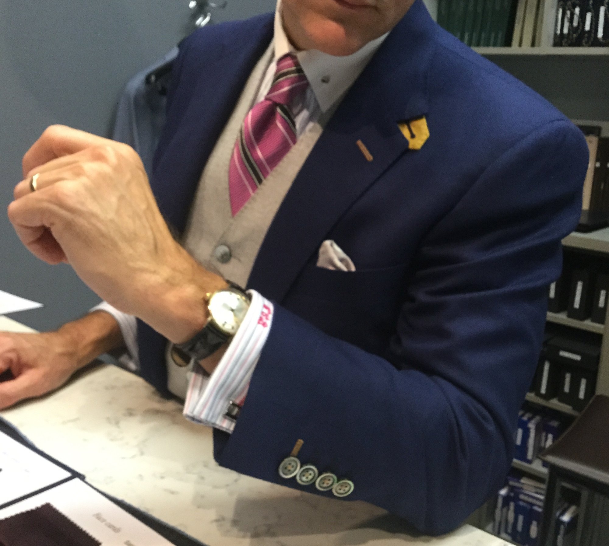 Christian Boehm discussing bespoke suit details with a client at Bespoke By CB Miami showroom