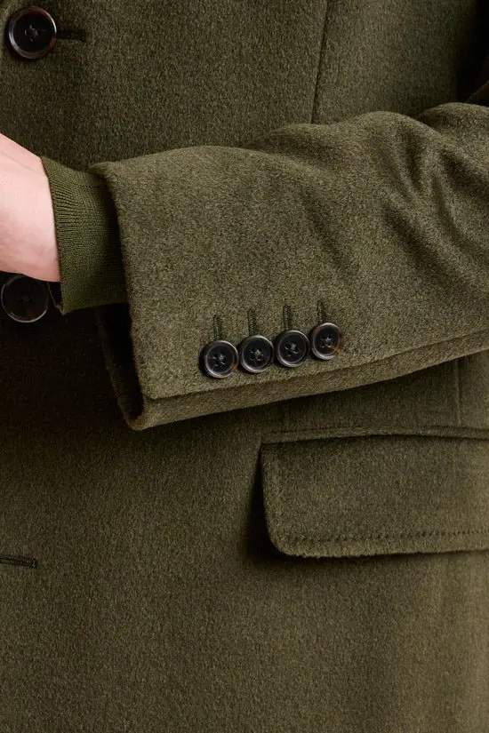 Man wearing a custom olive green suit tailored by Bespoke By CB in South Florida