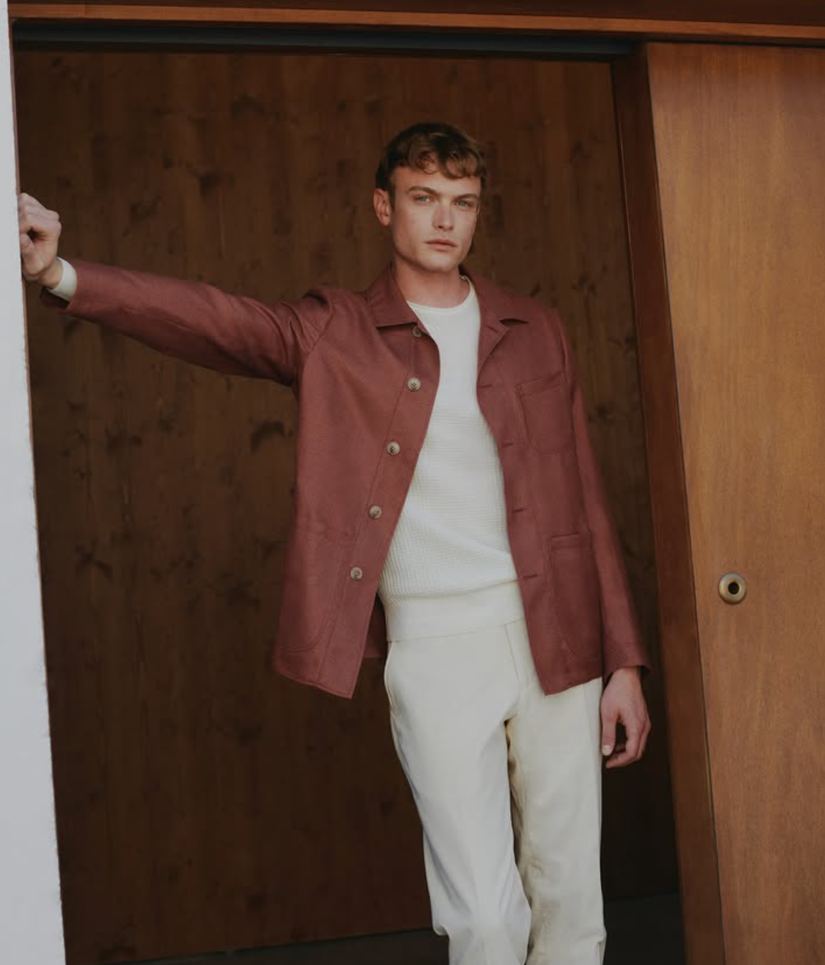 Custom rust shirt jacket styled with white crew neck and cream trousers for a relaxed Miami look