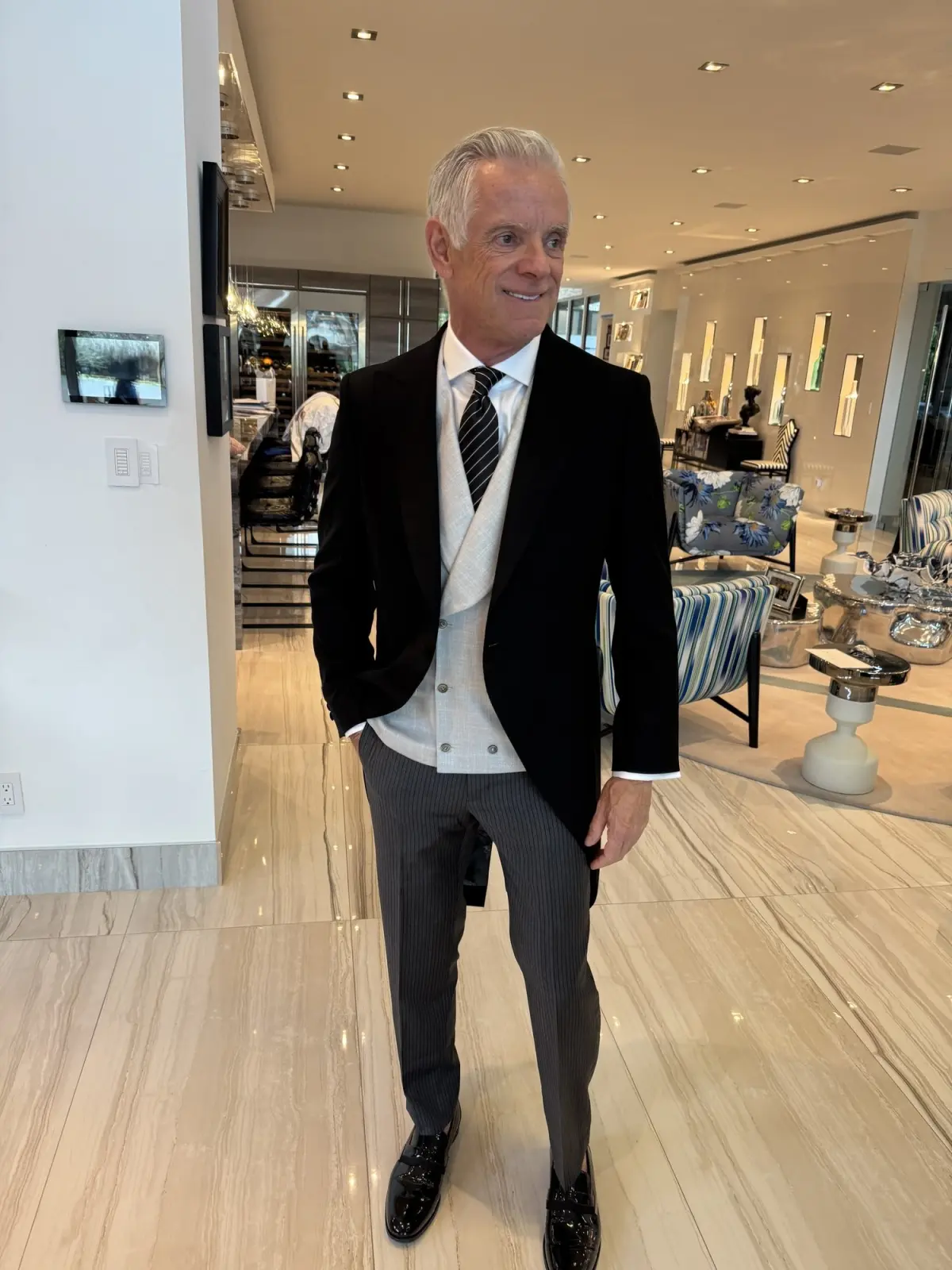 Bespoke black morning coat with grey double-breasted waistcoat and pinstripe trousers — classic Royal Ascot attire