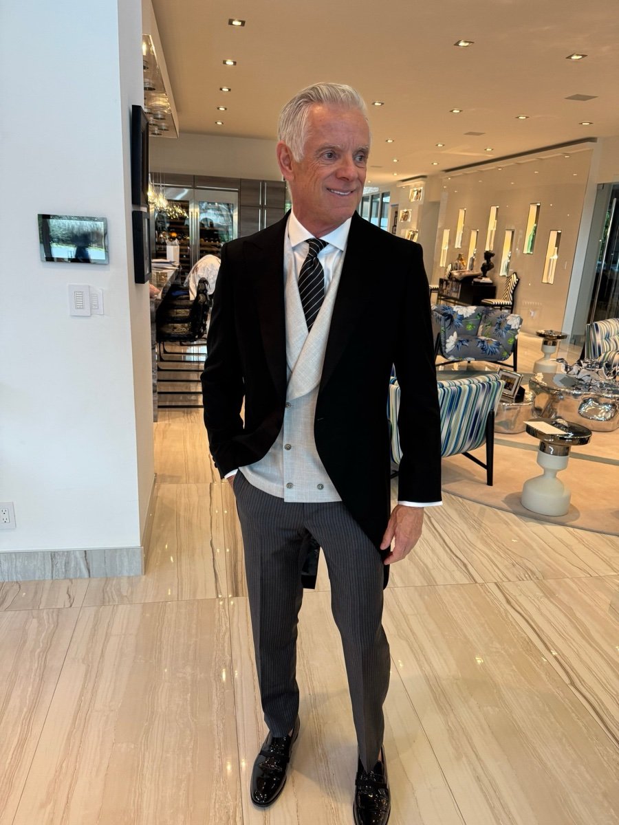 Gentleman wearing a custom tailcoat tuxedo jacket with tails at Bespoke By CB showroom in Miami