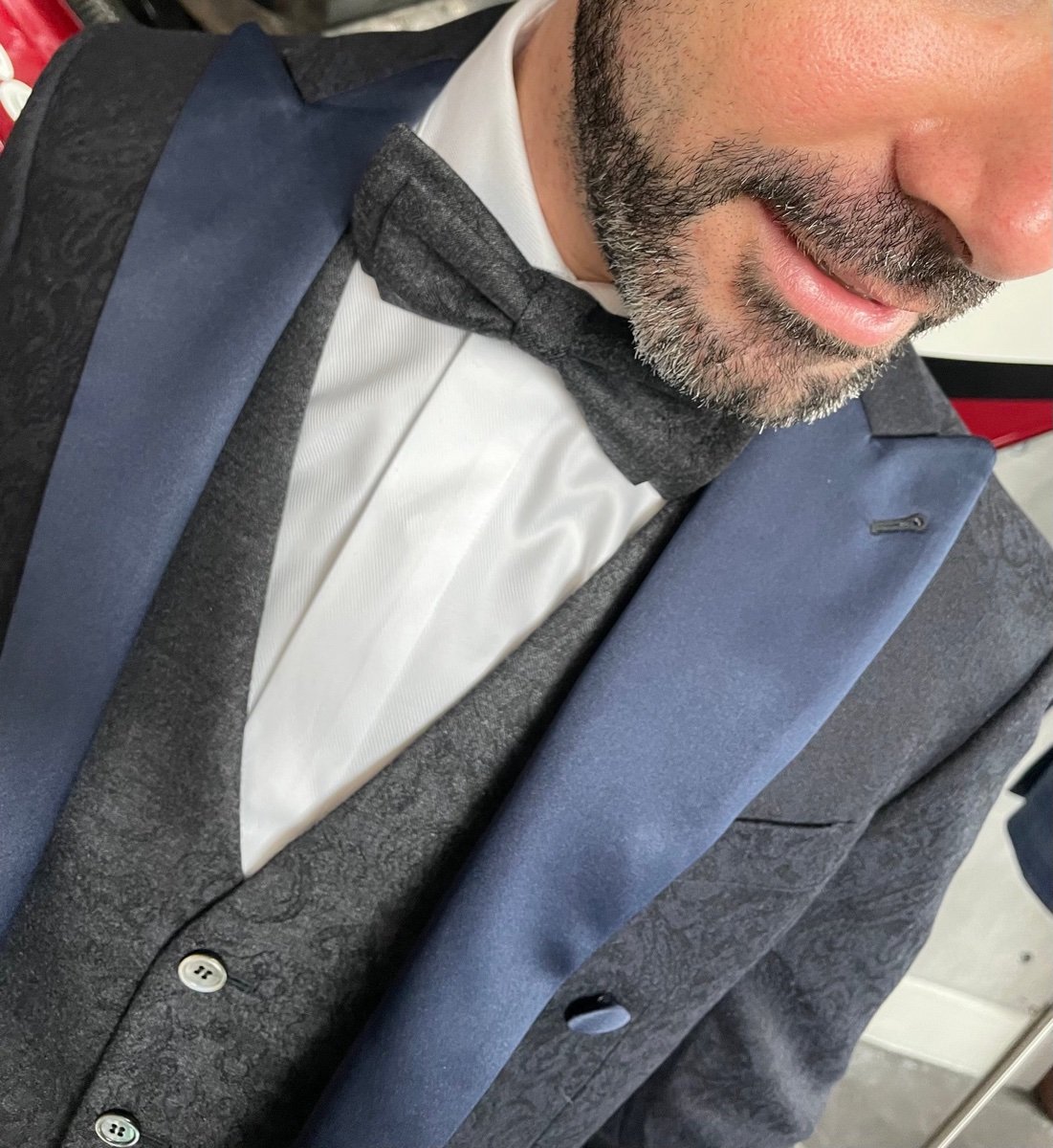Close-up of a paisley waistcoat with bow tie and satin lapels for white tie formalwear