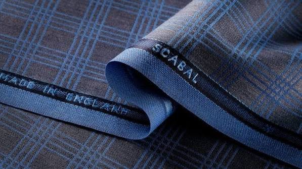 Premium suit fabric collection showing wool silk and linen options for custom suits at Bespoke By CB Miami