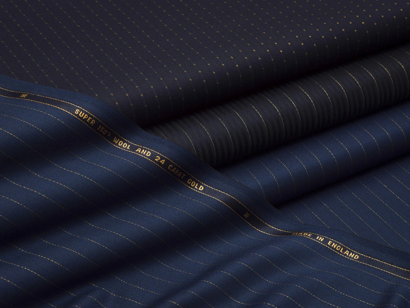 Luxury suit fabric sample box with premium wool silk and cashmere swatches at Bespoke By CB Miami