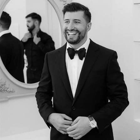 Custom bespoke tuxedo with satin lapel detailing on a groom at his Miami wedding