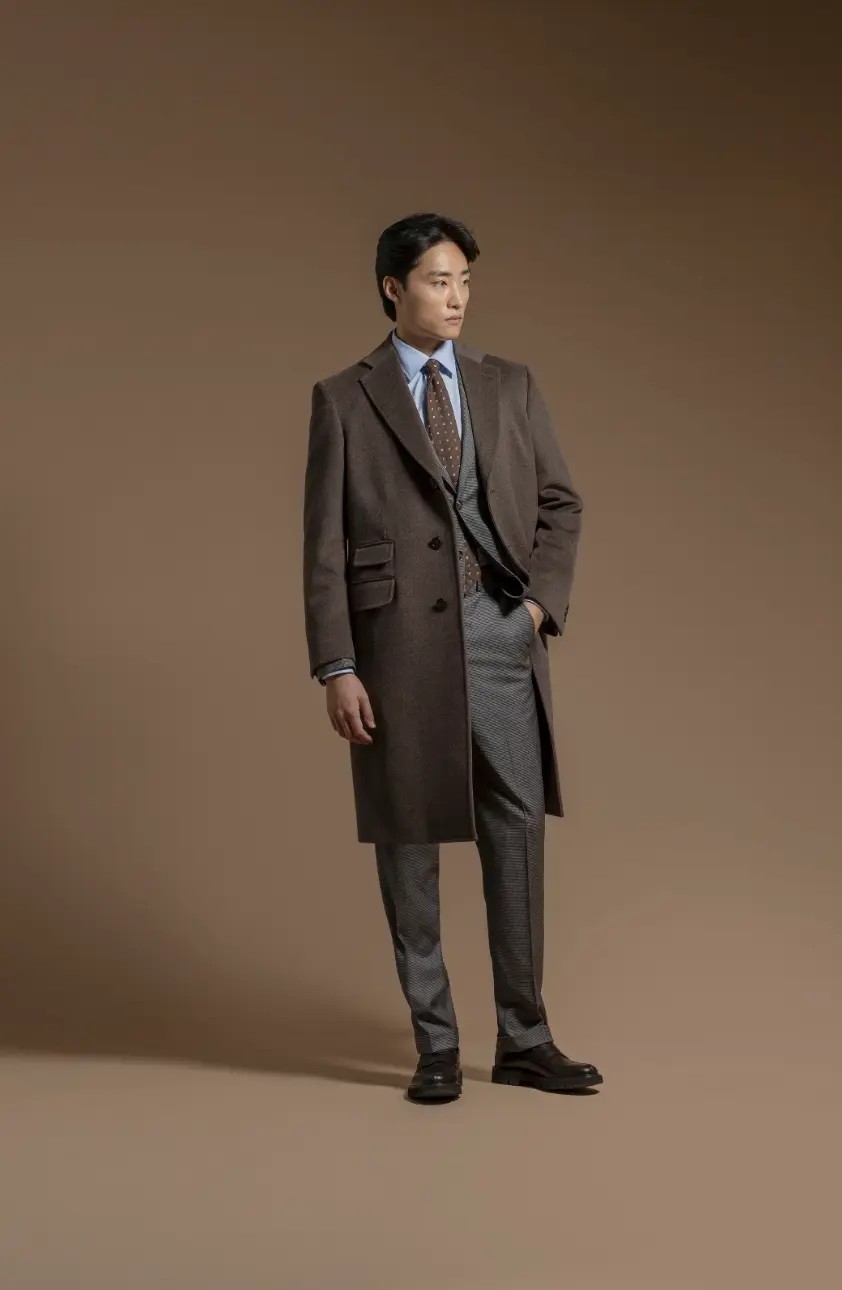 Brown tweed Chesterfield overcoat with ticket pocket styled over a grey check suit