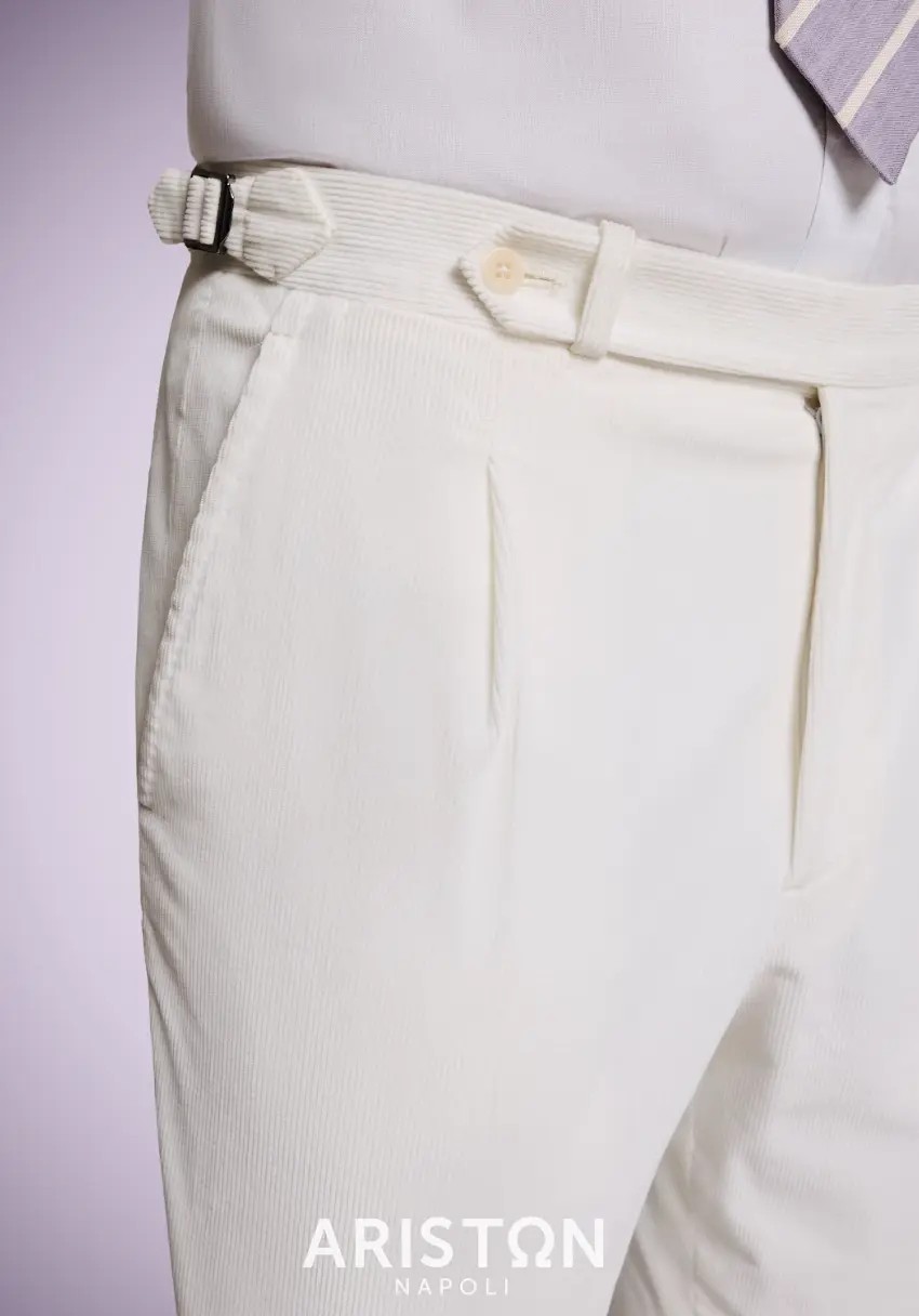 Cream fine-wale corduroy trousers with single pleat and side adjusters styled with white shirt and purple tie