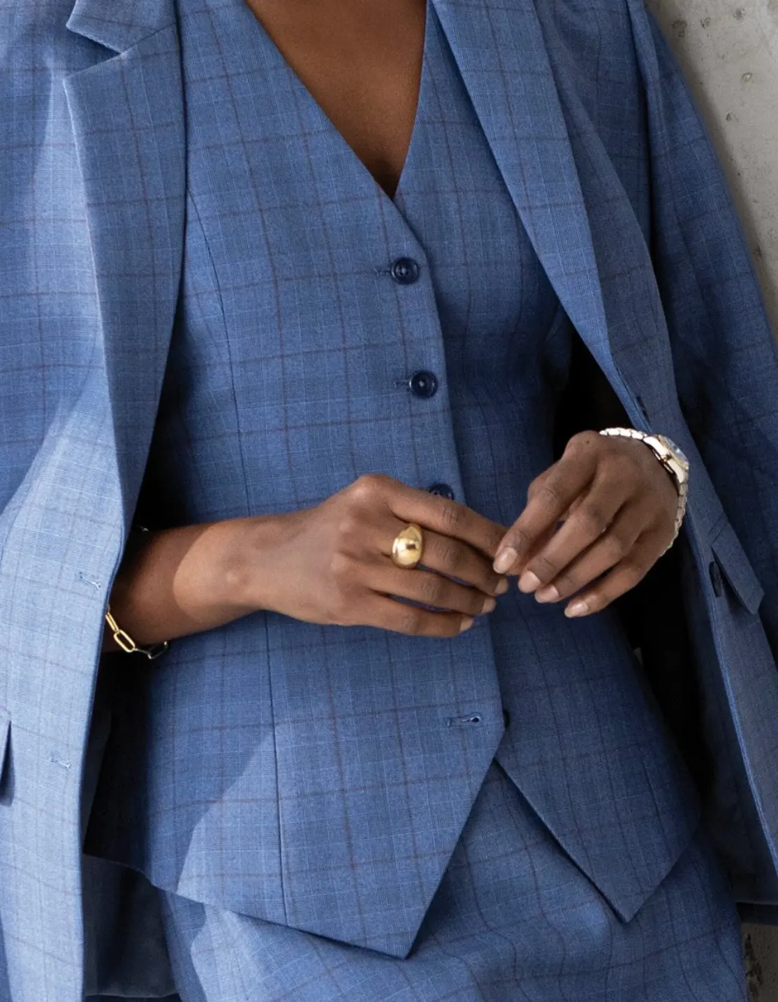 Woman’s blue plaid vest with gold jewelry, three-piece women’s suit styling by Bespoke By CB Miami