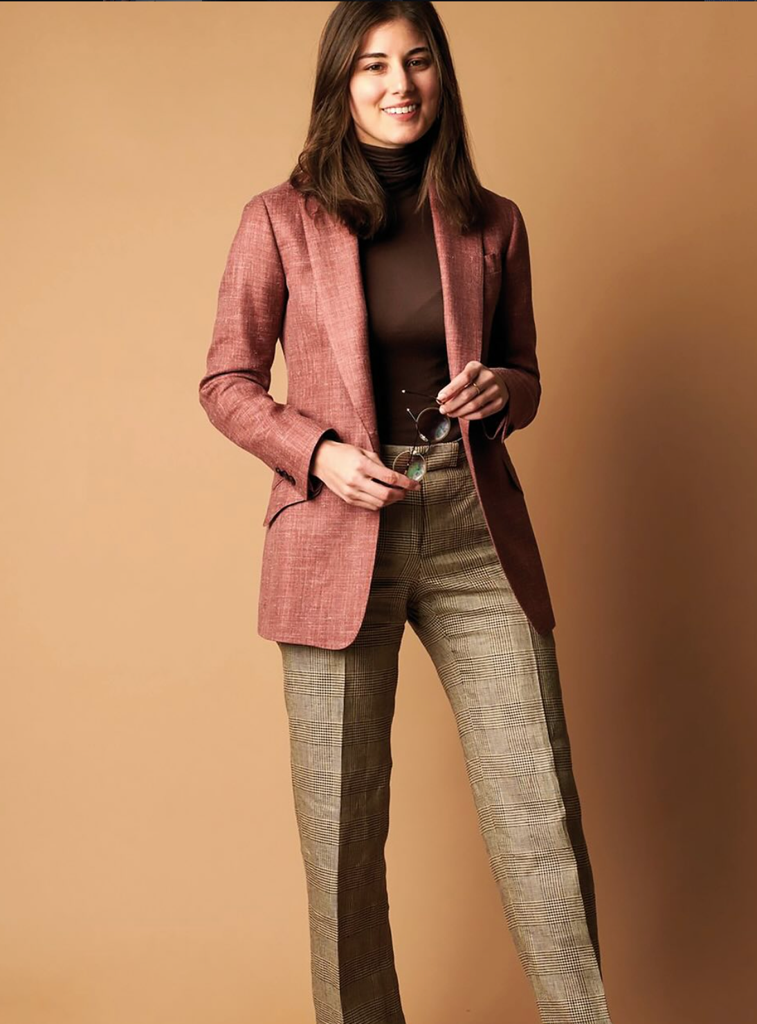 Woman in terracotta blazer with plaid trousers, custom suit pants styling by Bespoke By CB