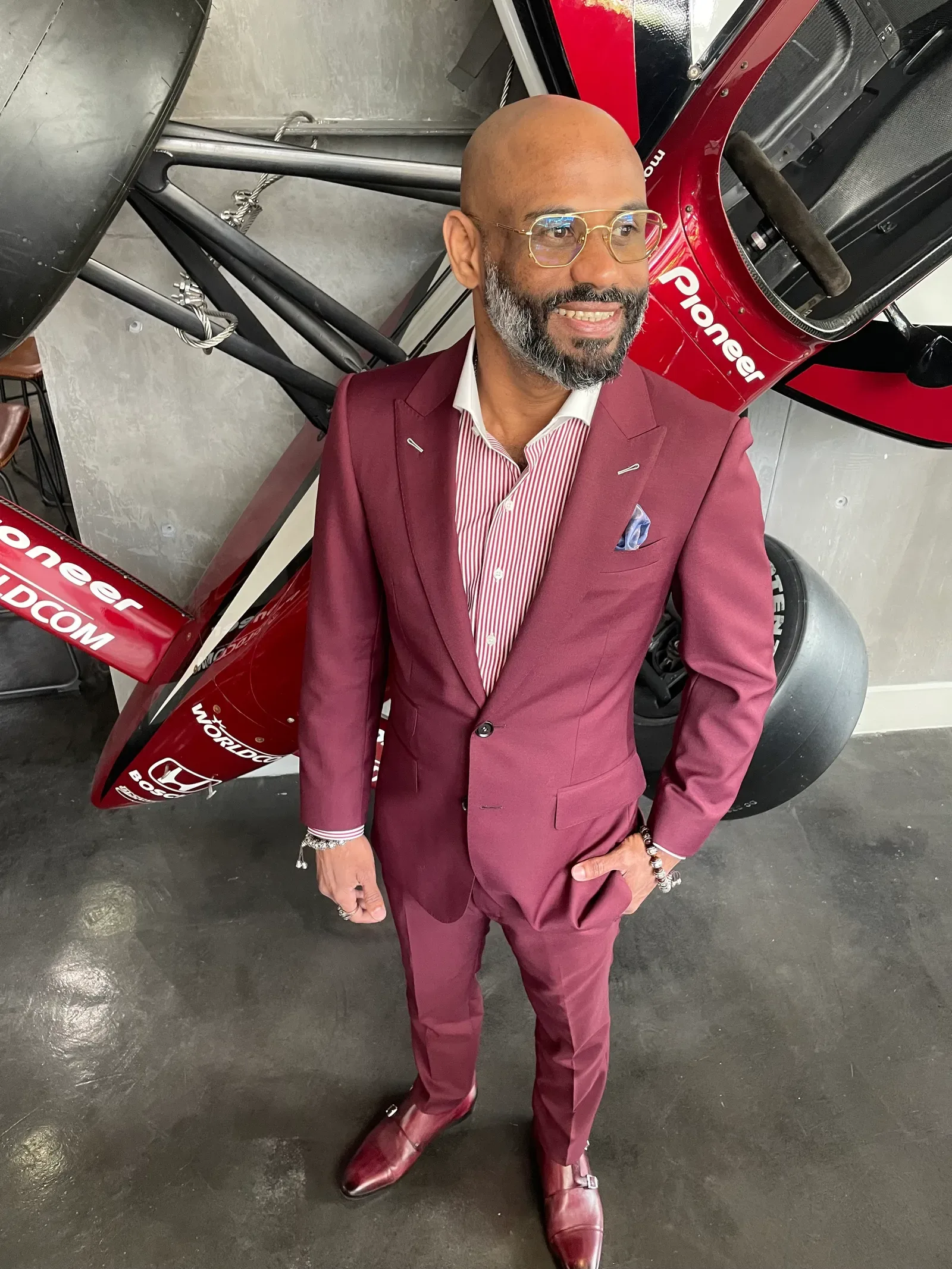 Man wearing a bold burgundy suit, the quintessential holiday color for cocktail parties and festive gatherings.