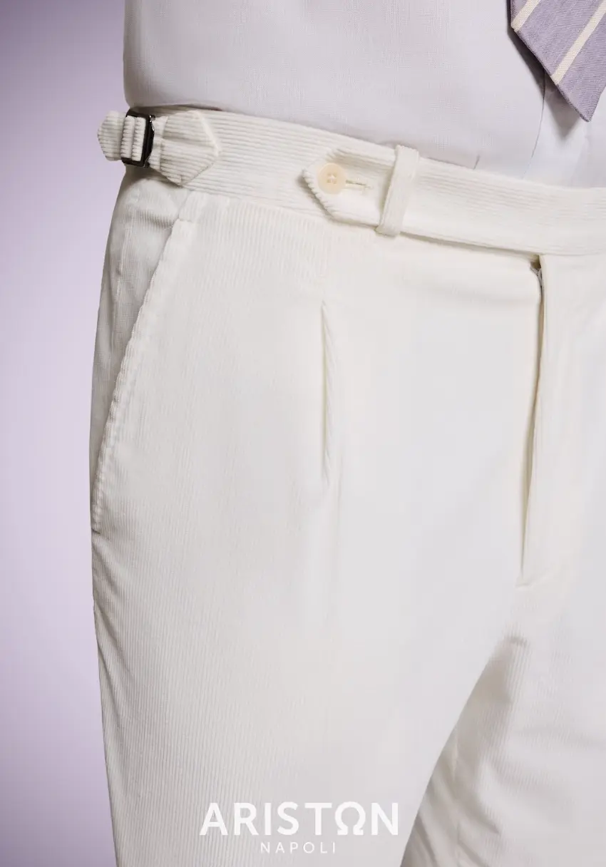Cream fine-wale corduroy trousers with single pleat and side adjusters styled with white shirt and purple tie