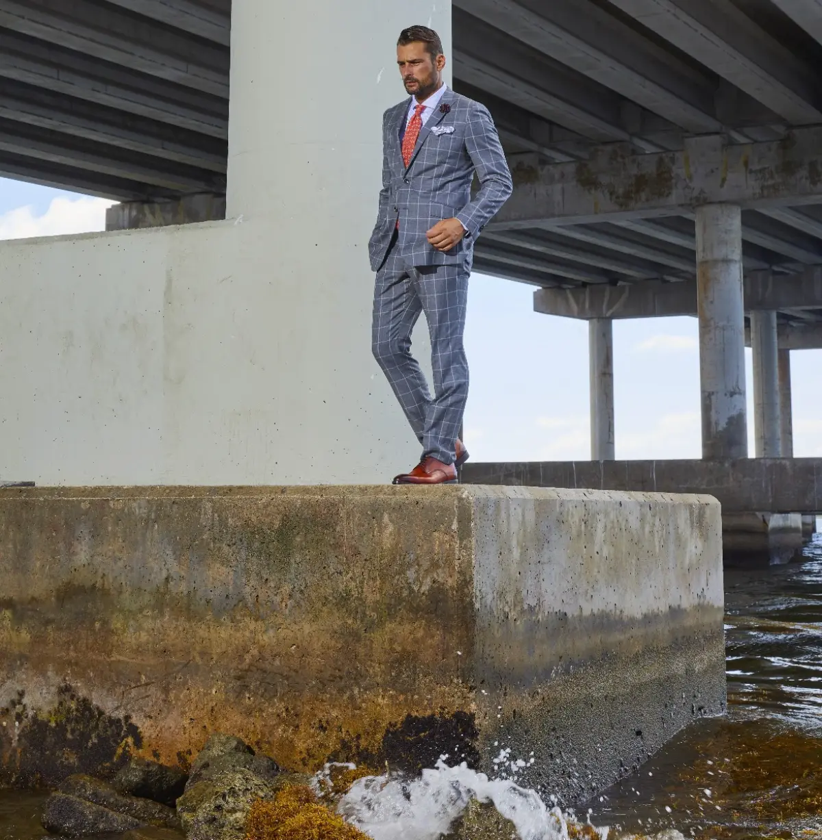 A windowpane slim fit grey suit showcases the precision and quality of custom tailoring available at Bespoke By CB in Miami