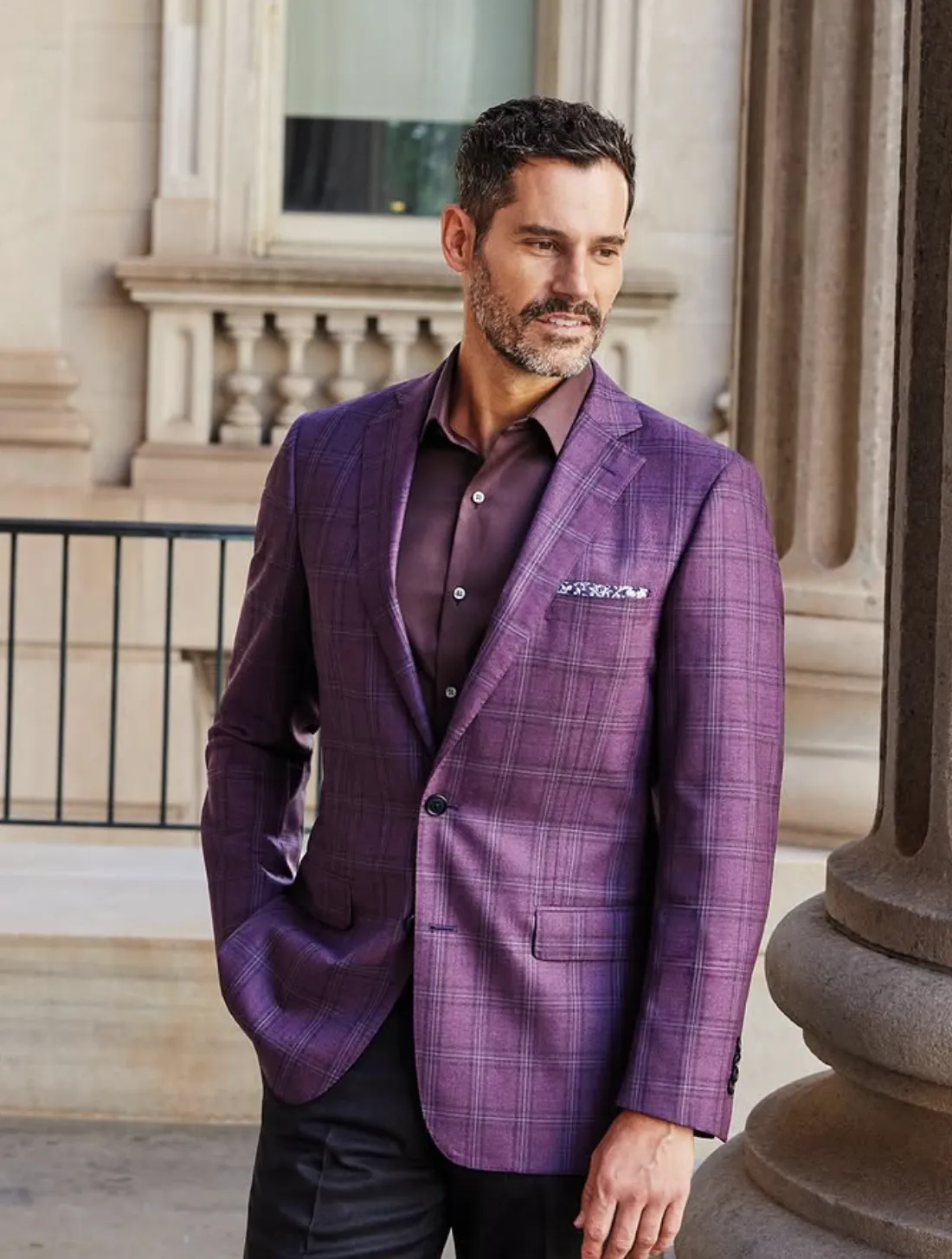 Man wearing custom purple plaid sport coat in Gladson Bamboo III fabric, standing outdoors with clean drape and natural movement