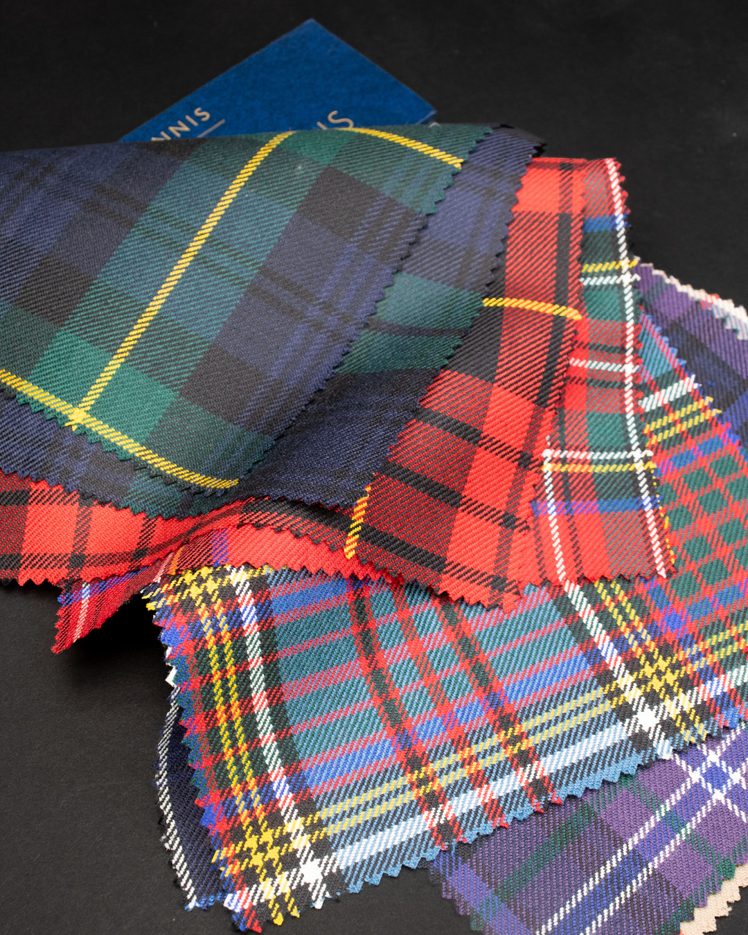 Scottish tartan fabric swatches in rich plaid patterns woven in the Scottish Borders