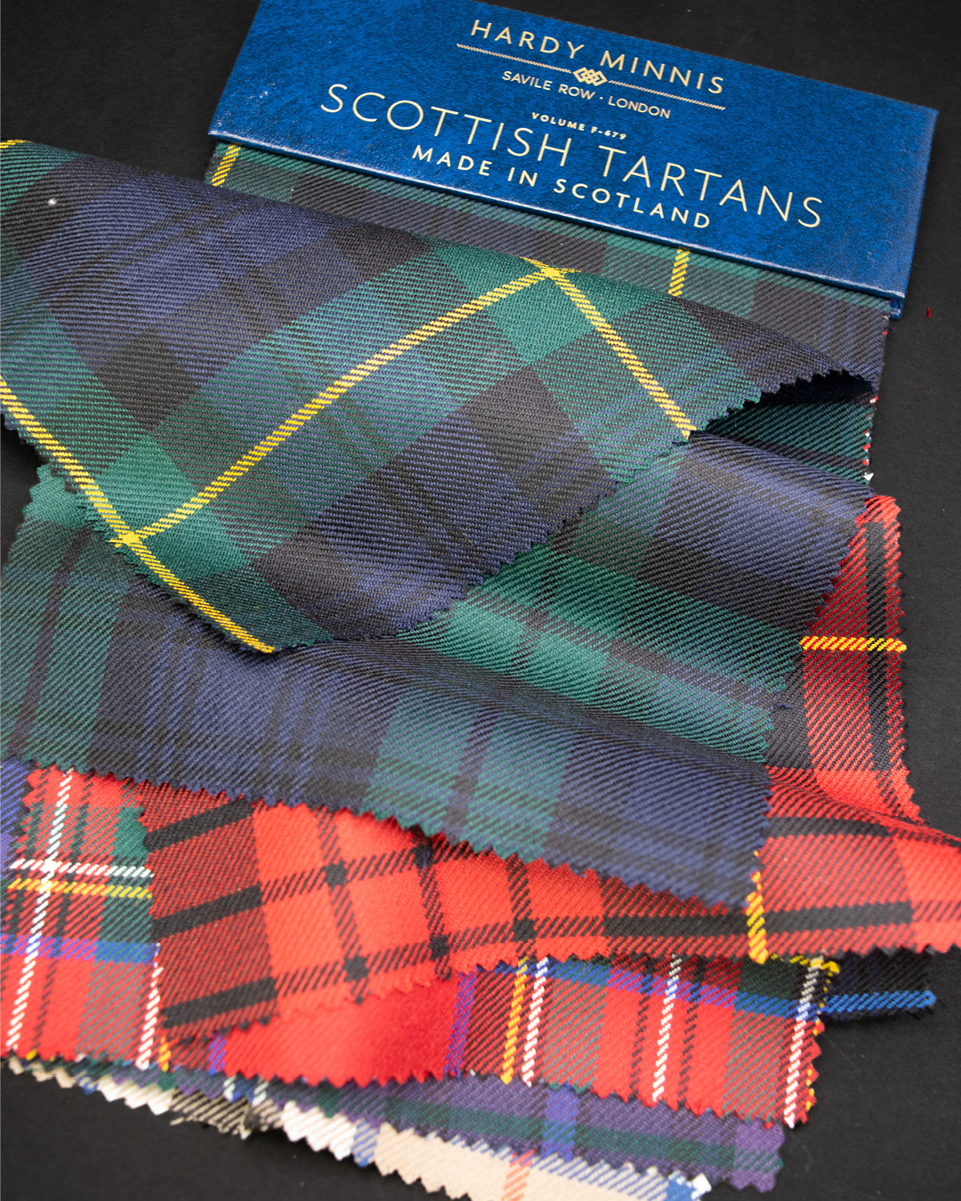 Stacked Scottish tartan swatches showing the range of plaid colors and patterns