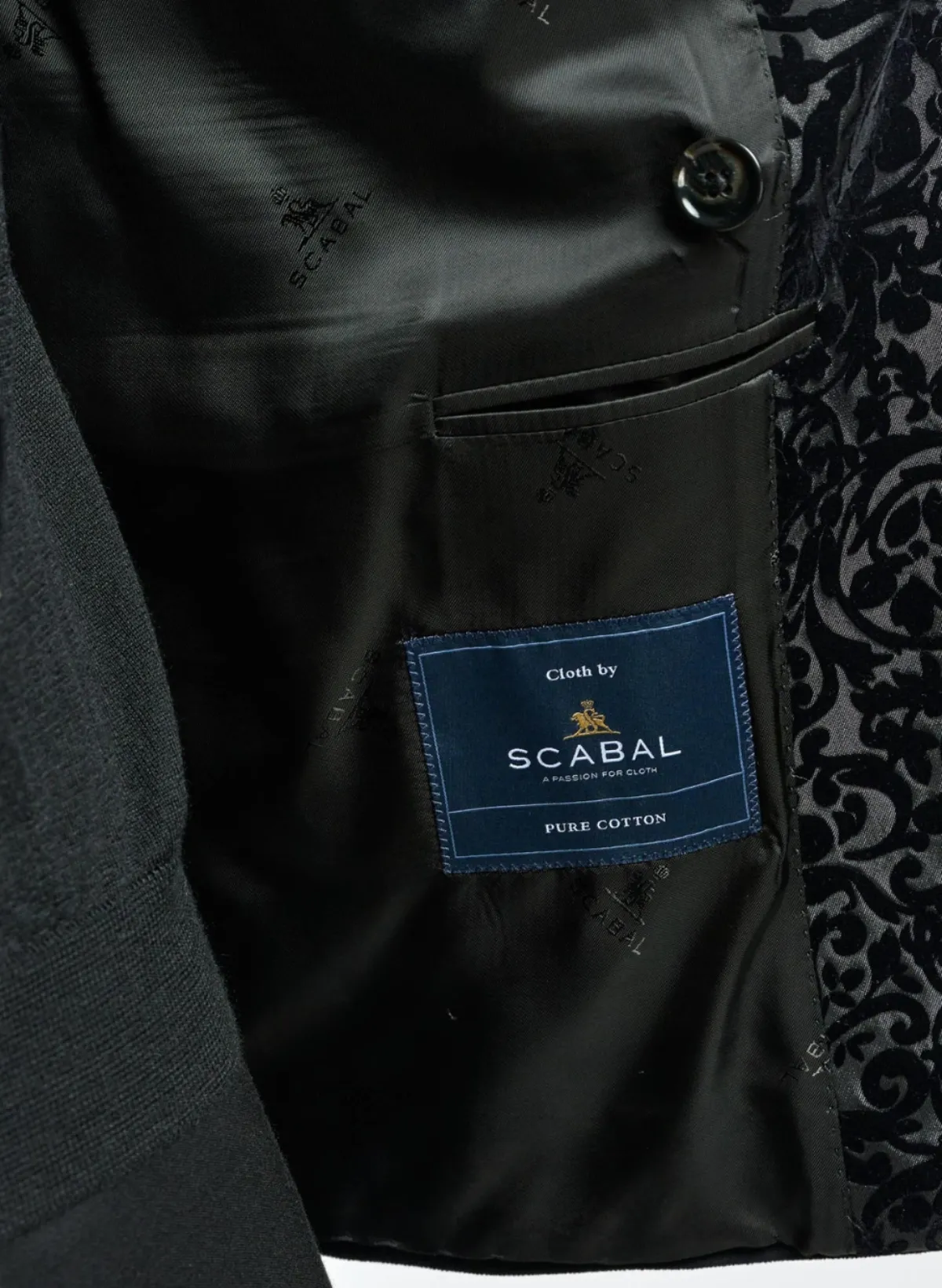 Close-up comparison of Italian and English wool suit fabrics at Bespoke By CB, showing the difference in weave, texture, and drape between Super 130s Italian wool and traditional English worsted