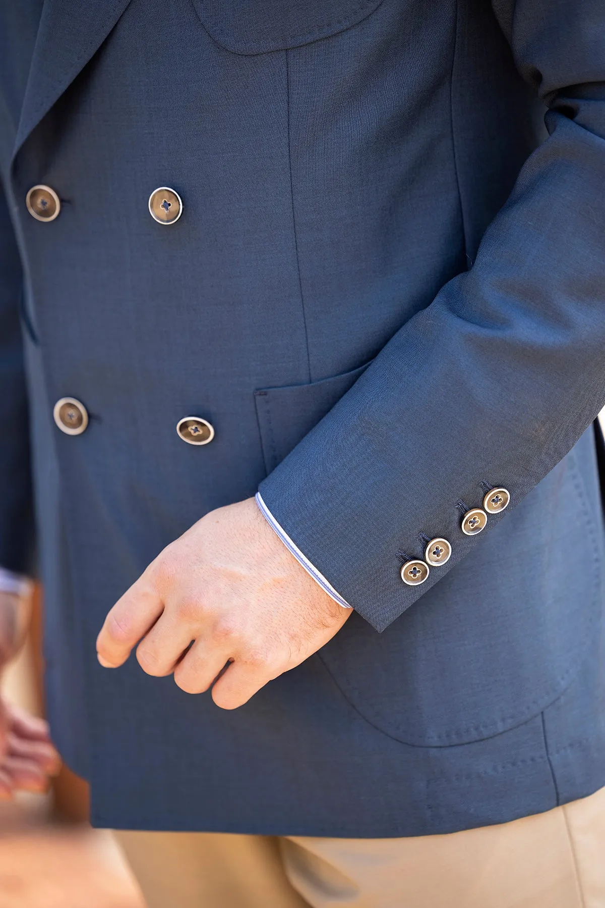 Navy double-breasted blazer with tan trousers styled for business casual in Miami