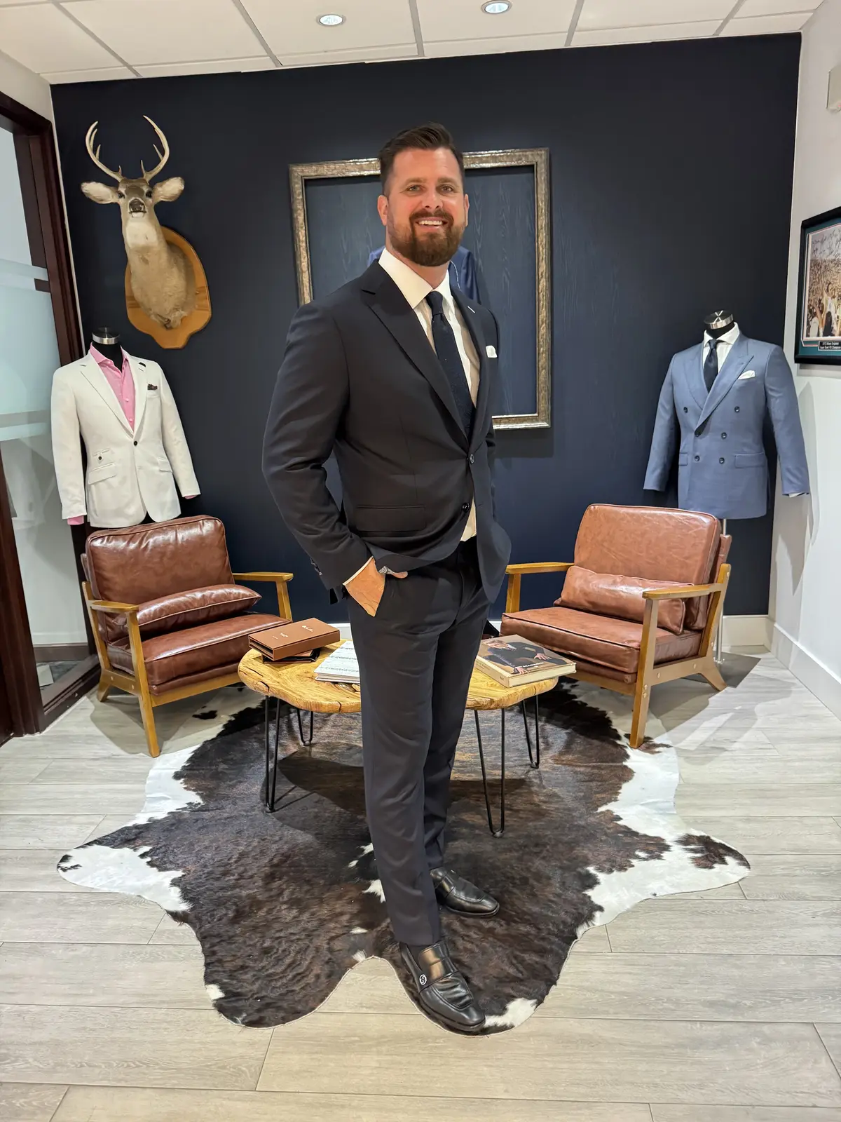 Custom clothing consultation at Bespoke By CB Miami showroom, selecting fabrics and taking measurements