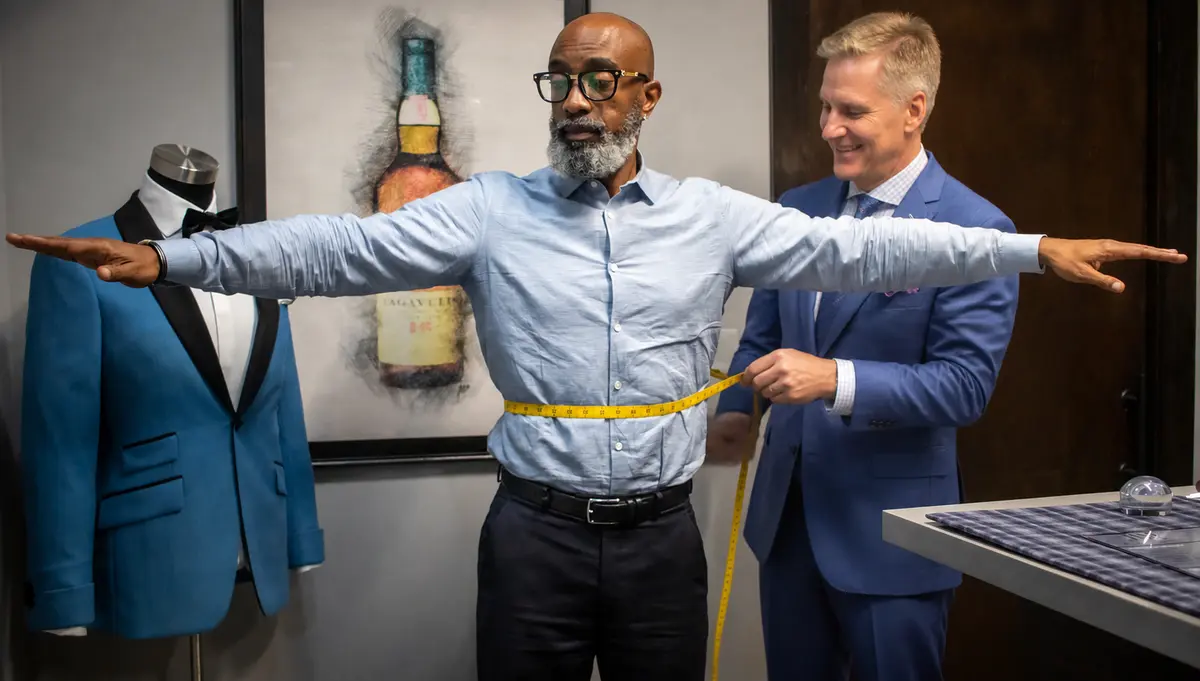 Taking measurements during a custom clothing consultation at Bespoke By CB
