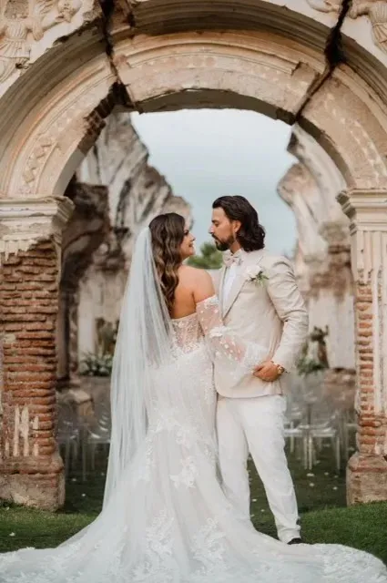 Elegant groom wearing a bespoke ivory linen suit for a tropical destination wedding.