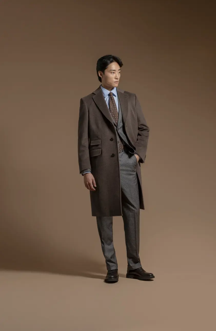 Brown tweed Chesterfield overcoat with ticket pocket styled over a grey check suit