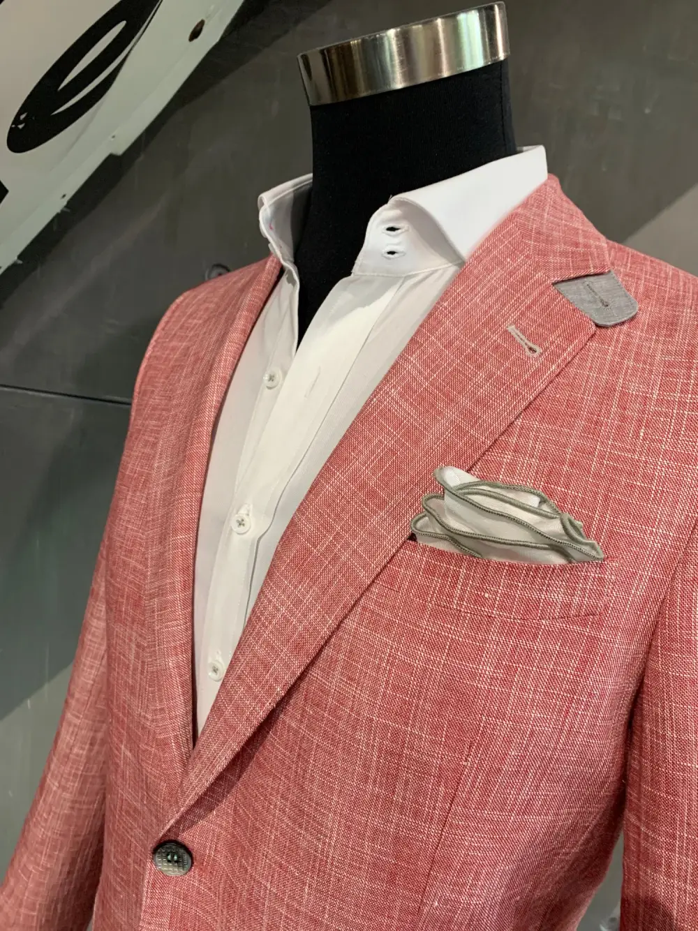 Salmon pink linen custom blazer on mannequin with white shirt and pocket square
