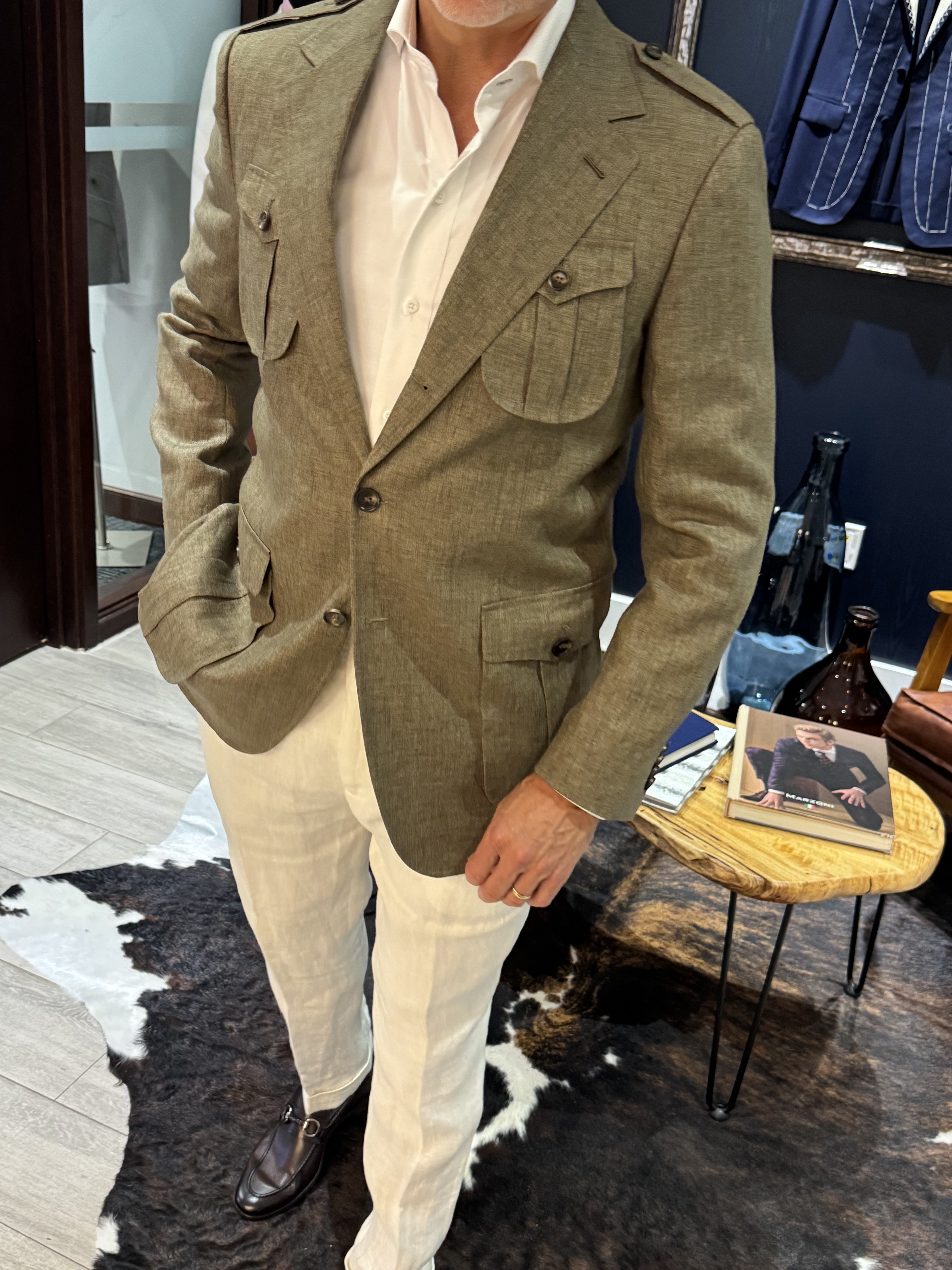 Olive safari blazer with bellows pockets and epaulettes shown from the side
