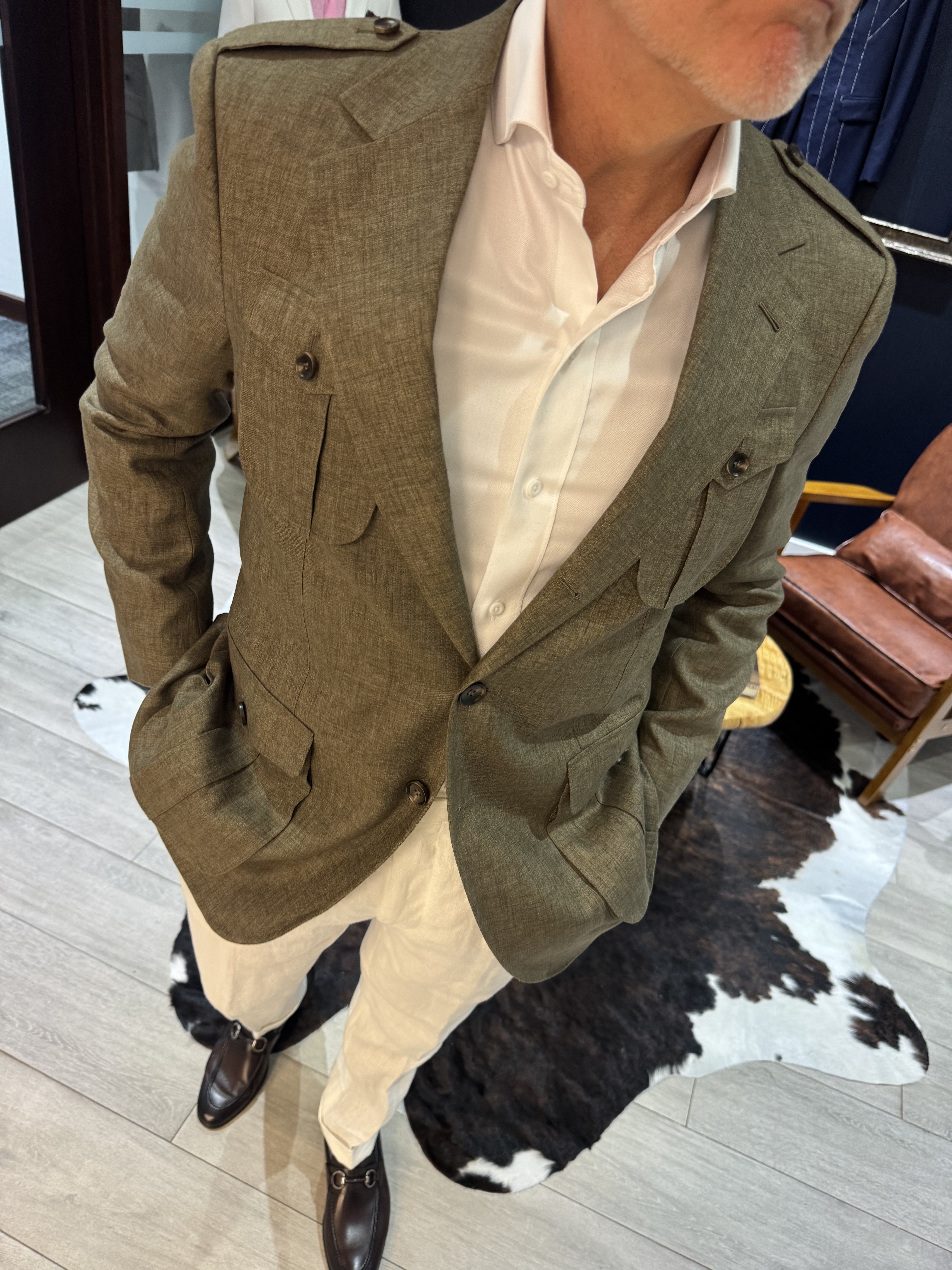 Man wearing safari style jacket with hands in pockets showing natural drape of linen fabric