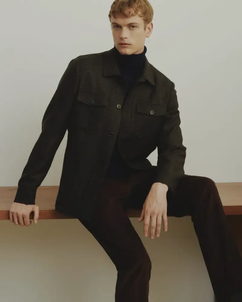 Glen plaid wool overshirt in brown and charcoal, layered over a navy turtleneck
