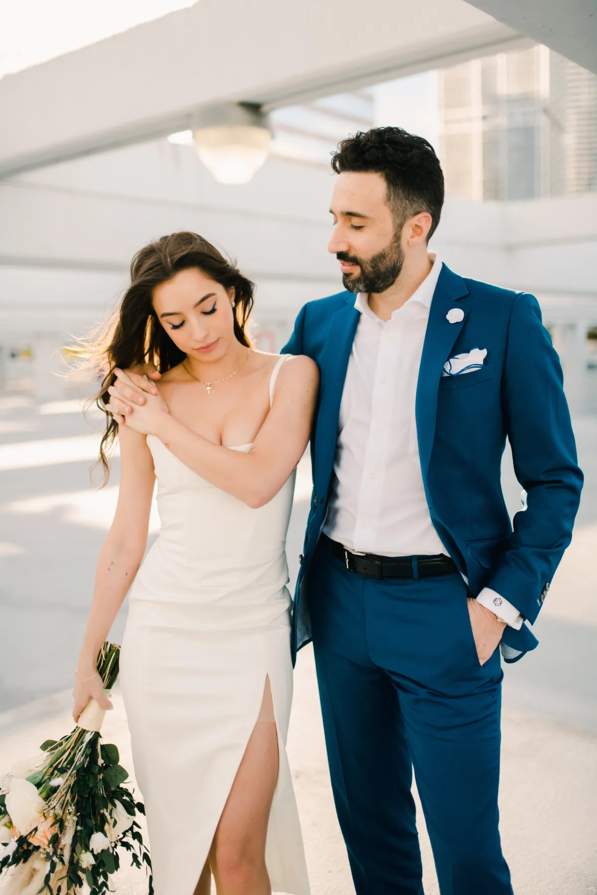 Royal blue custom trousers on a rooftop showing tailored fit without a belt.