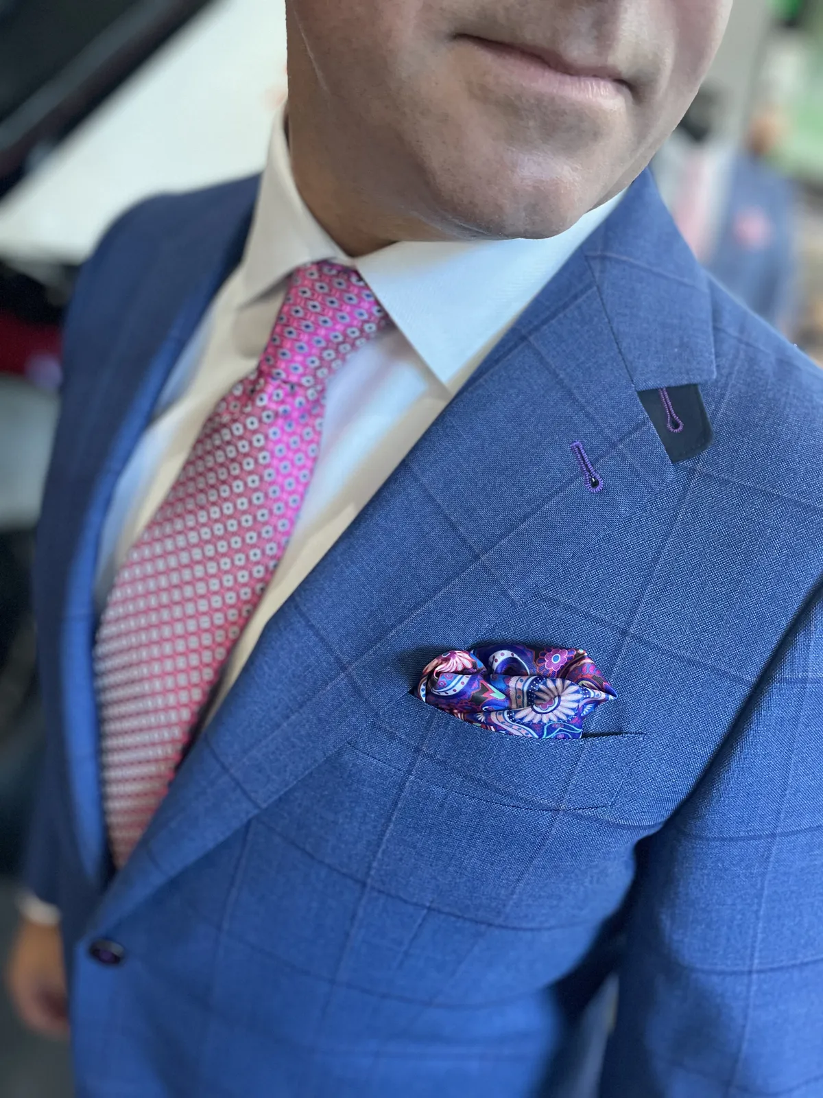 Custom blue windowpane suit with pink tie detail at Bespoke By CB