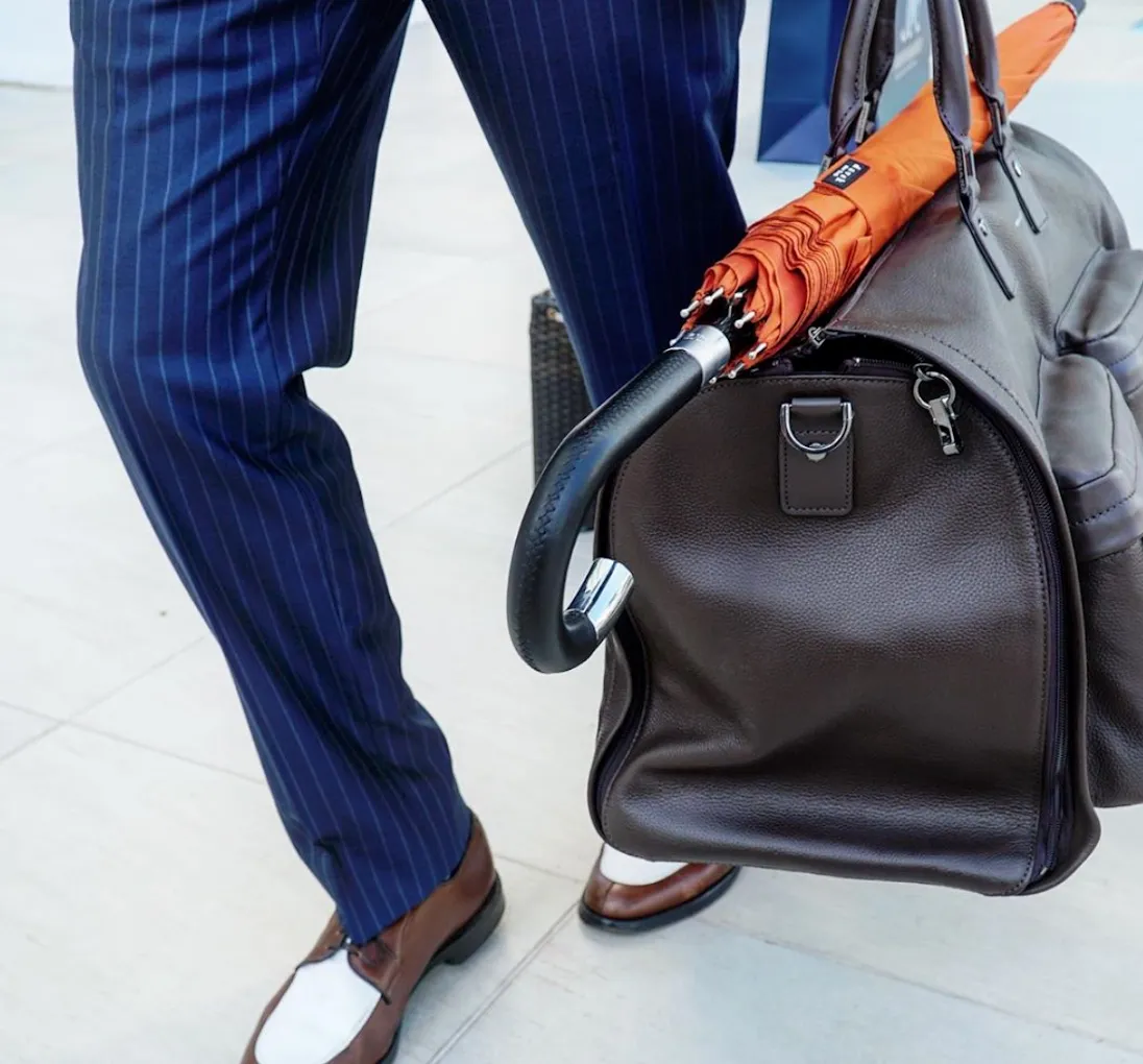 Detail of a navy pinstripe custom suit with spectator shoes in South Florida.