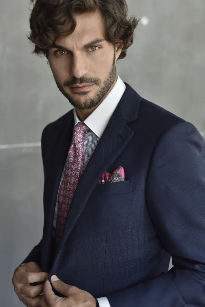 Custom navy textured suit with pink tie at Bespoke By CB Miami