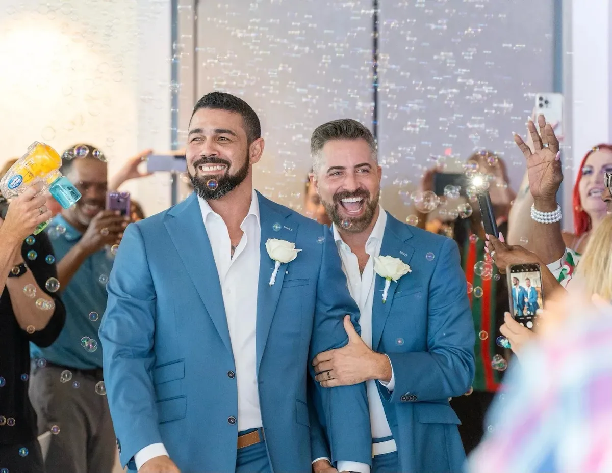 Custom blue wedding suit with matching groomsmen by Bespoke By CB Miami