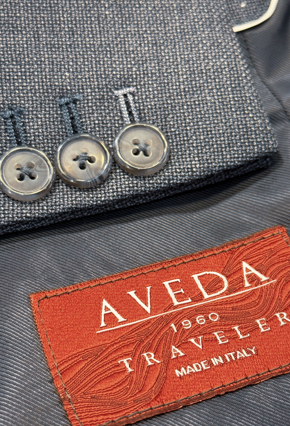 Aveda branded card with attached fabric swatch showing weave detail