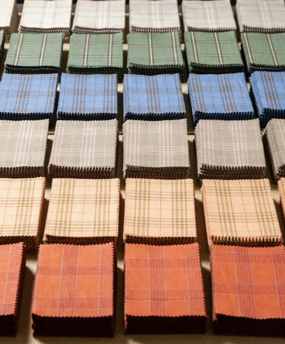 Grid of Dormeuil plaid fabric swatches showing the limitless options in true bespoke tailoring.