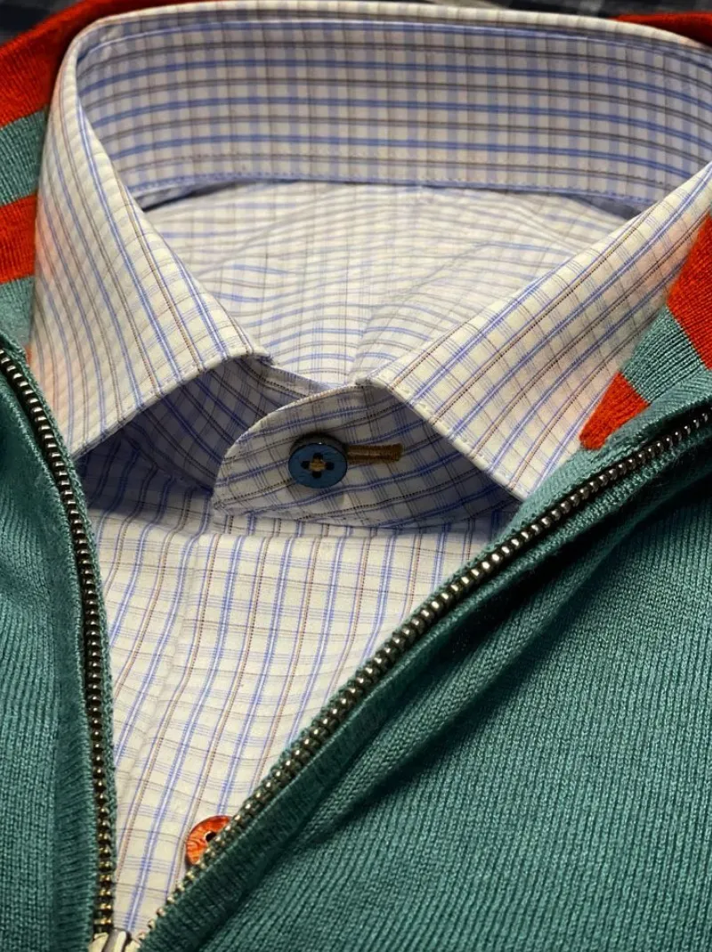 Gingham sport shirt layered under a quarter-zip sweater for smart casual styling.