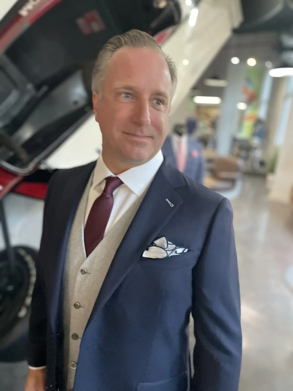 Professional wearing a navy custom suit in Miami tailored for warm weather.