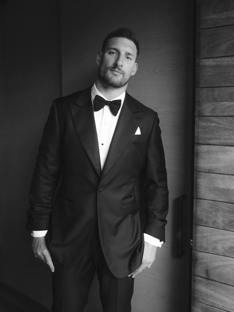 Joey Bosa in a custom black peak-lapel tuxedo with white pocket square and bow tie by Bespoke By CB
