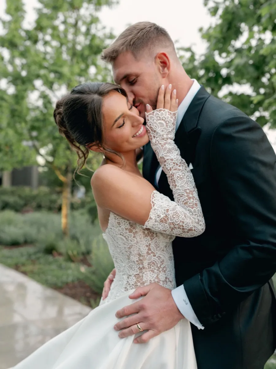 Close-up of Joey Bosa and Amanda in custom wedding attire showing monogrammed shirt cuff detail by Bespoke By CB